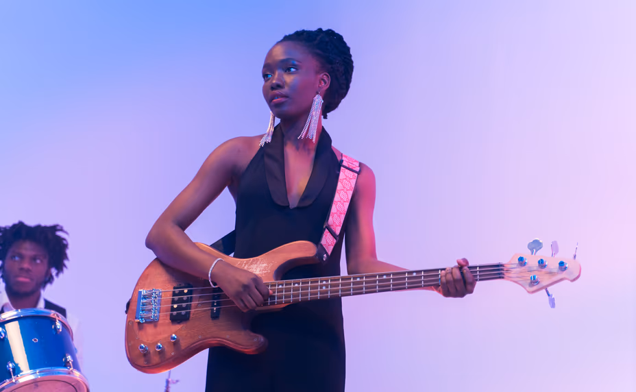 Contestant performing with a bass guitar on stage